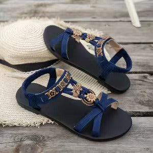 👡 50% RABATT NU! 🌸 Kvinnors Runda Tå Platta Andningsbara Sandaler – Blommiga Metalldetaljer, Justerbar Rem & Dämpad Fotbädd ✨
